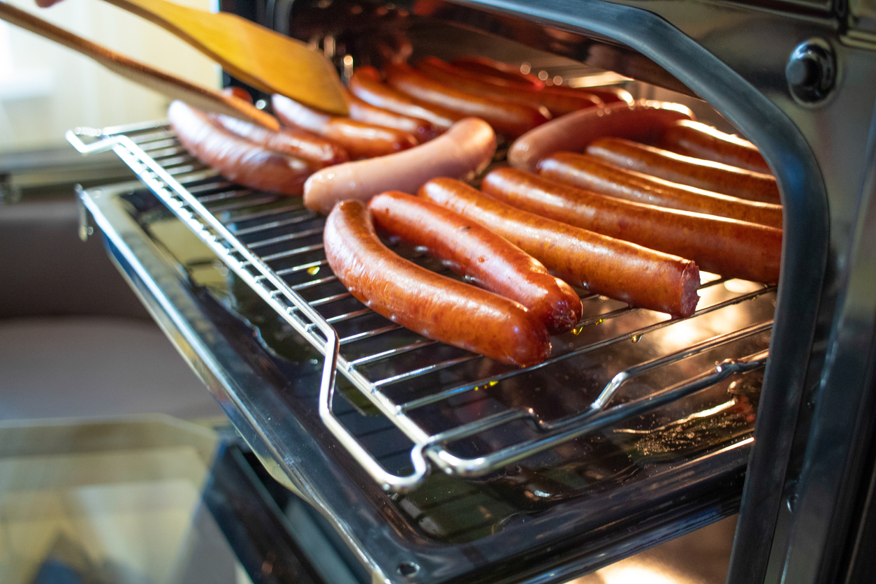 Cooking sausages in the oven. Fast food street.